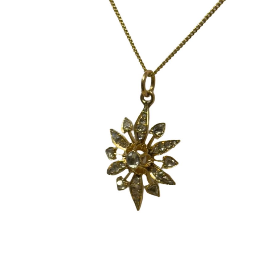 Gold necklace with a star-shaped pendant on a white card