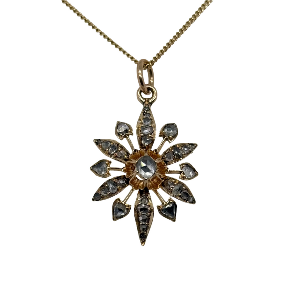 Gold necklace with a star-shaped pendant on a light gray background