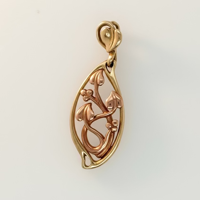 Gold pendant on a white background