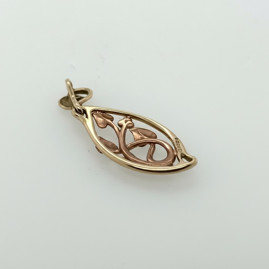 Gold pendant on a light gray background